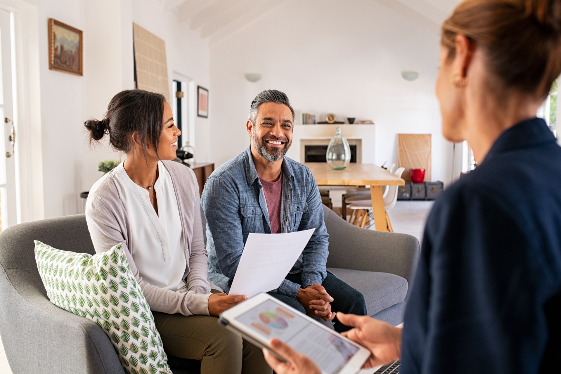 Couple talking to financial advisor at home